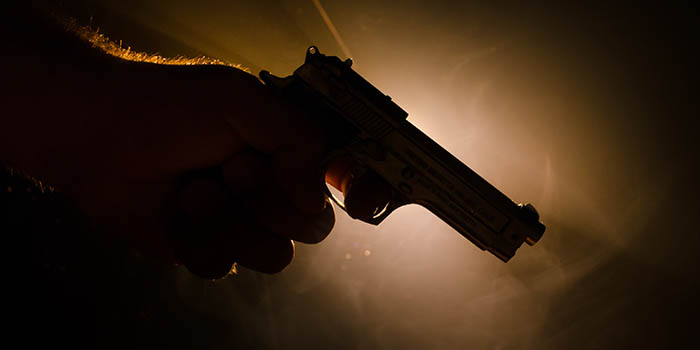 A man holds a gun
